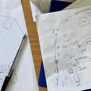 Pen beside paper sketches of a water supply